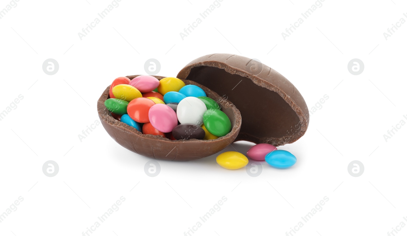 Photo of Broken chocolate egg with colorful candies on white background