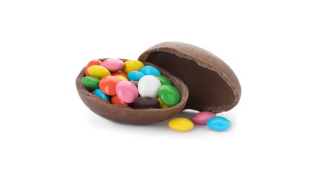 Photo of Broken chocolate egg with colorful candies on white background