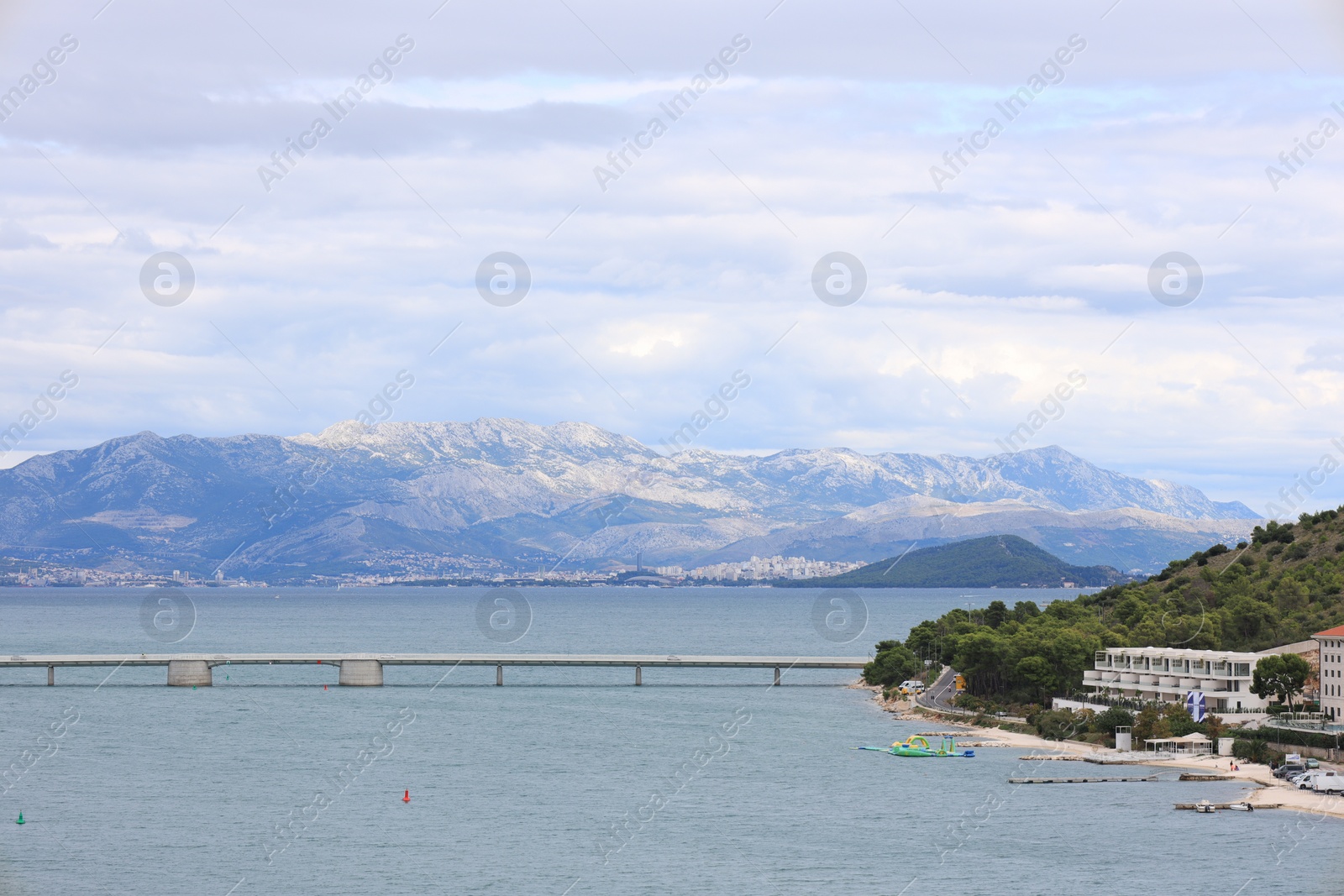 Photo of Picturesque view of town, moored boats and sea on cloudy day