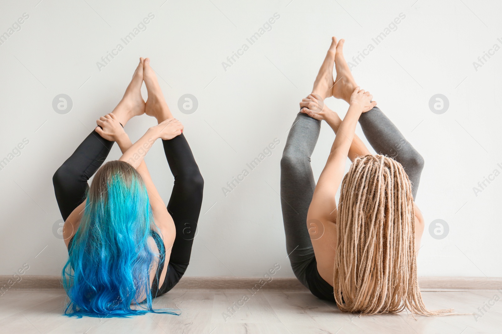 Photo of Young women practicing yoga indoors