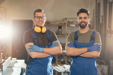 Photo of Portrait of professional male carpenters in workshop
