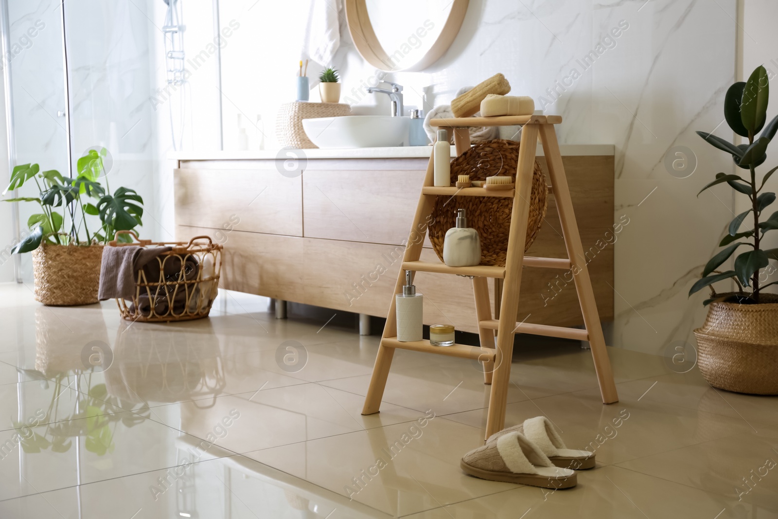 Photo of Dispensers and different toiletries on decorative ladder in bathroom. Idea for interior design