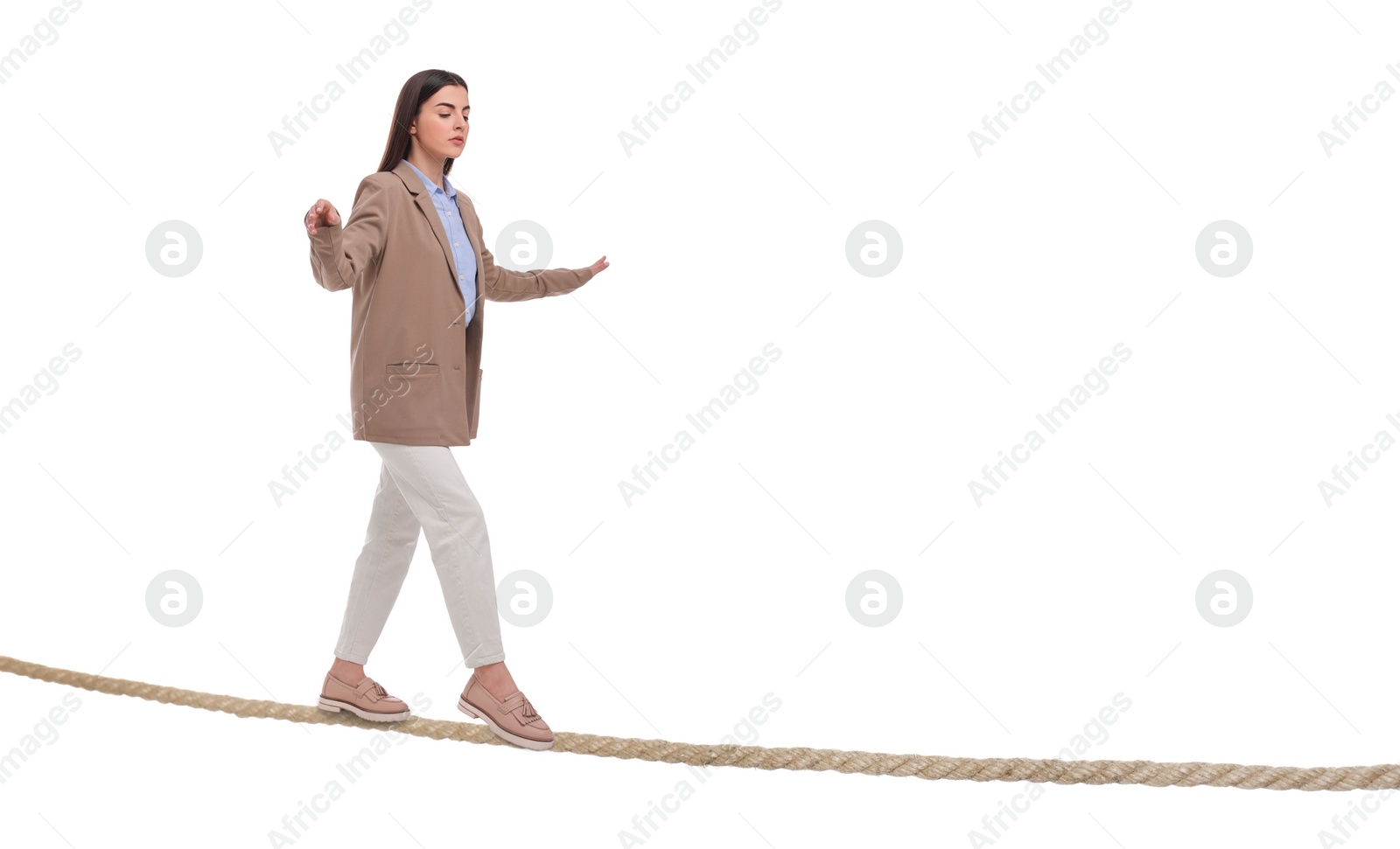 Image of Businesswoman walking rope against white background. Risk or balance concept