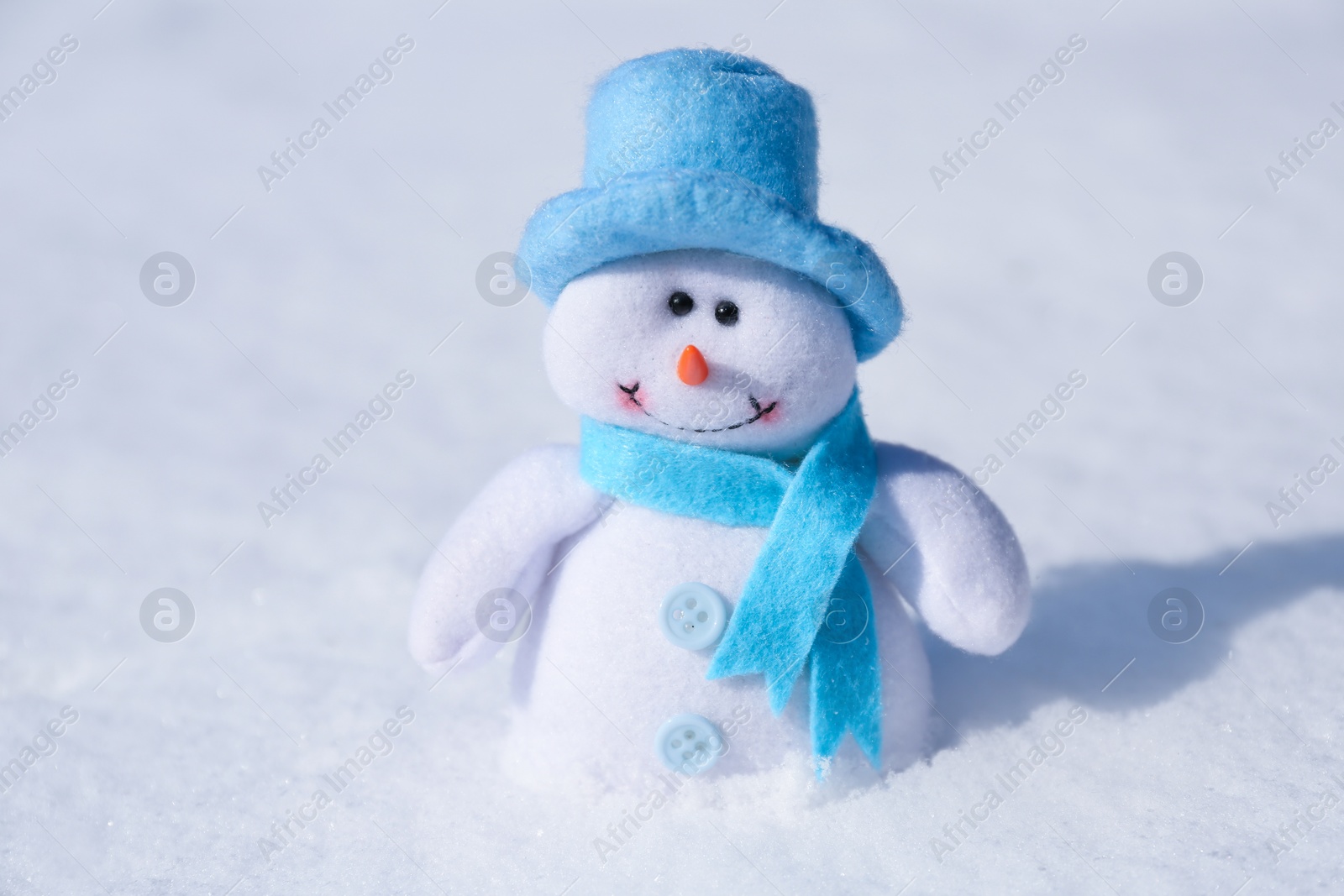 Photo of Cute small decorative snowman on snow outdoors