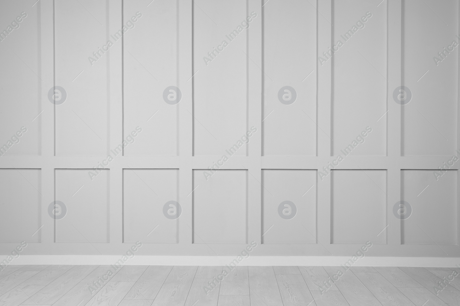 Photo of Empty white wall and wooden floor in room