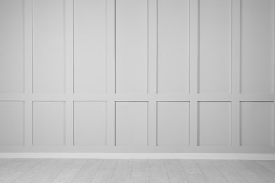 Empty white wall and wooden floor in room