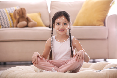 Adorable little girl with chickenpox at home