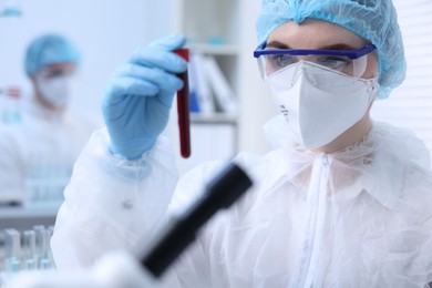 Scientist working with sample in test tube in laboratory