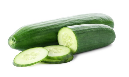 Photo of Whole and sliced fresh cucumbers on white background