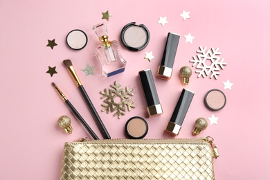 Photo of Flat lay composition with decorative cosmetic products on pink background. Winter care