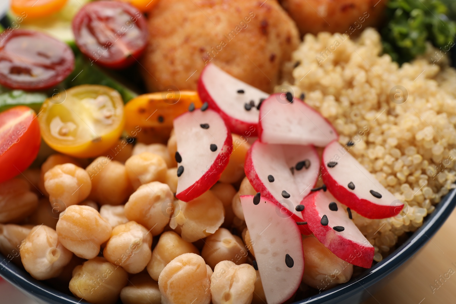 Photo of Delicious vegan bowl with chickpeas and radish on table, closeup