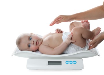 Photo of Young woman weighting cute baby on white background. Health care