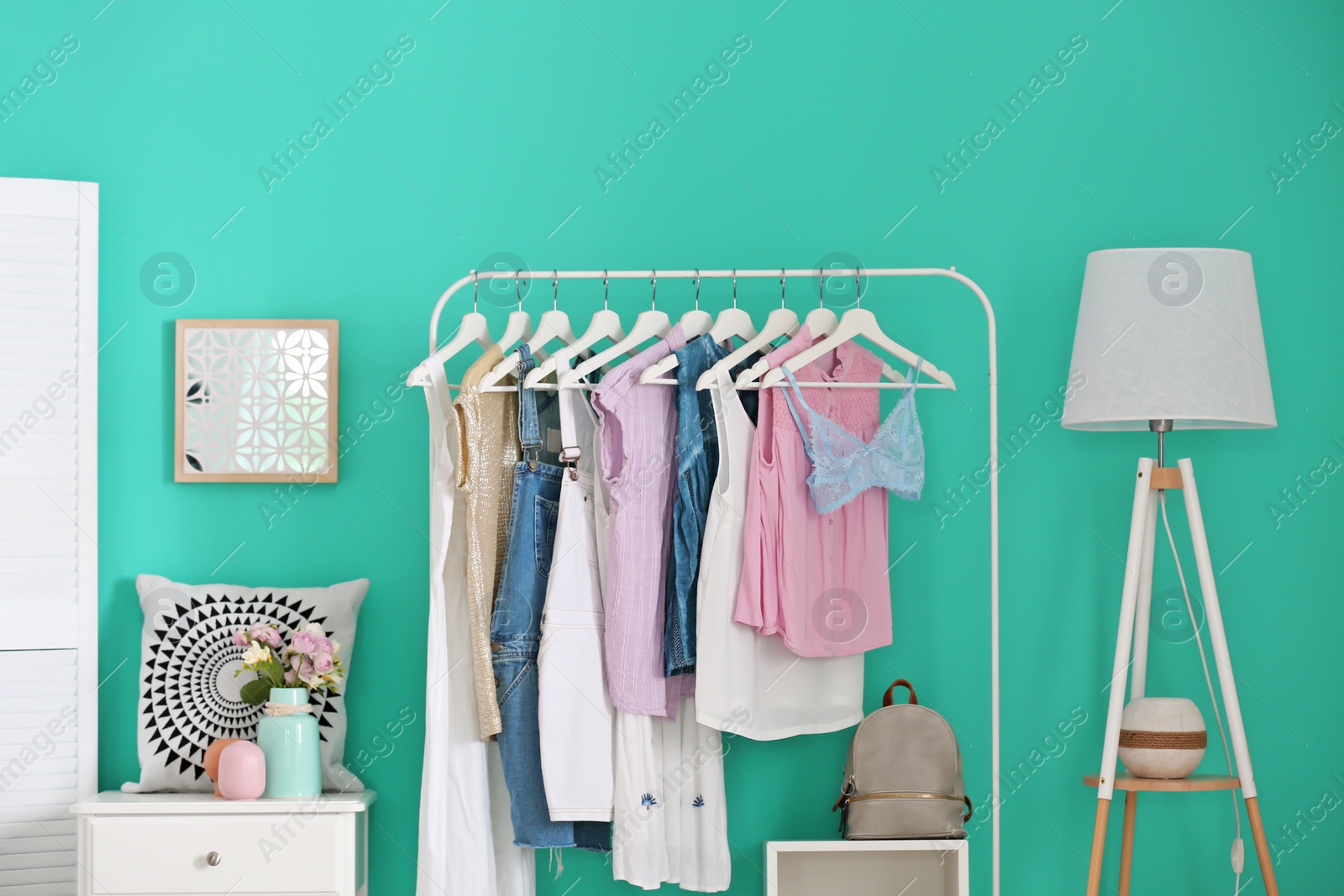 Photo of Stylish dressing room interior with clothes rack