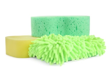 Photo of Sponges and car wash mitt on white background