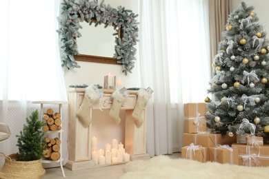 Photo of Cozy room interior with mirror, fireplace and Christmas tree