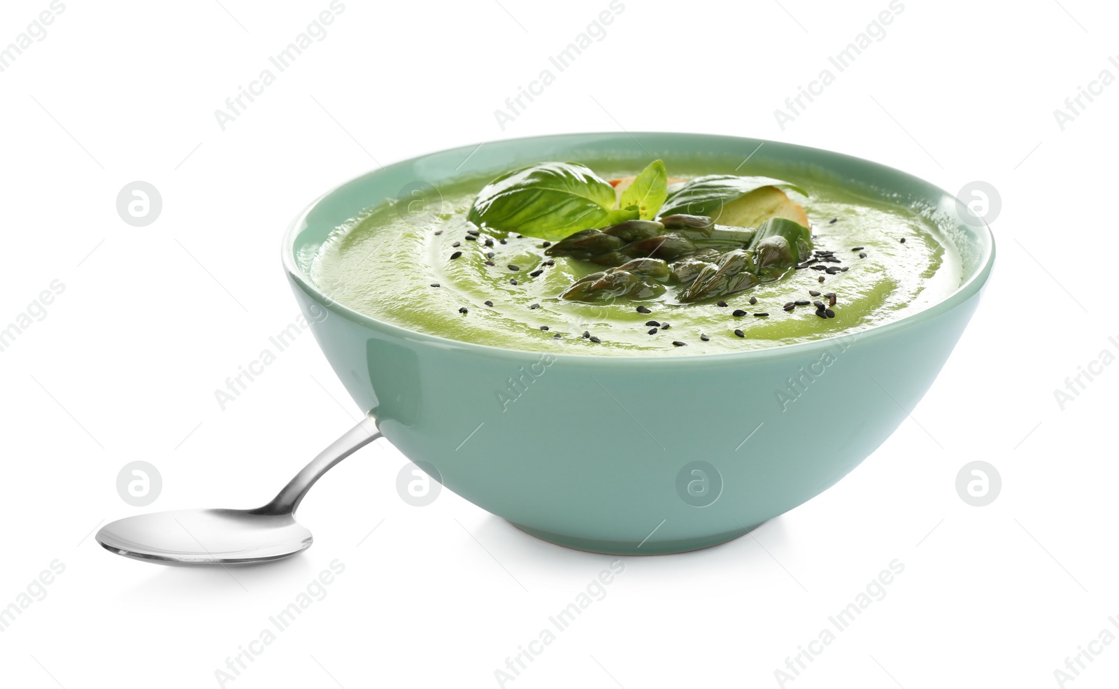 Photo of Delicious asparagus soup with basil and sesame seeds isolated on white