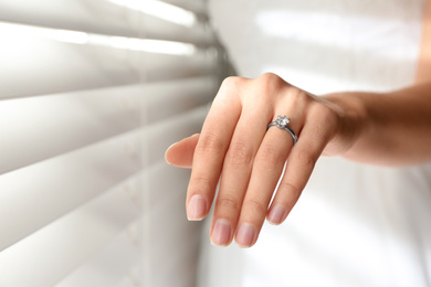 Young bride wearing beautiful engagement ring, closeup