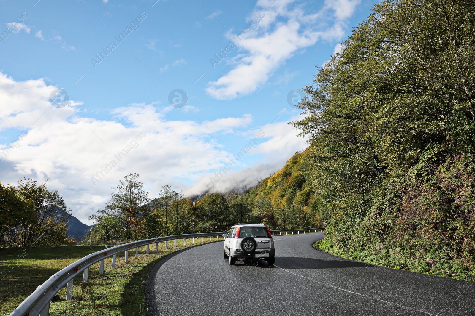 Photo of Picturesque view of road with car in mountains