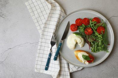 Delicious burrata cheese with tomatoes, arugula and toast served on grey table, top view. Space for text