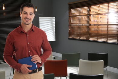 Young teacher waiting for students in classroom