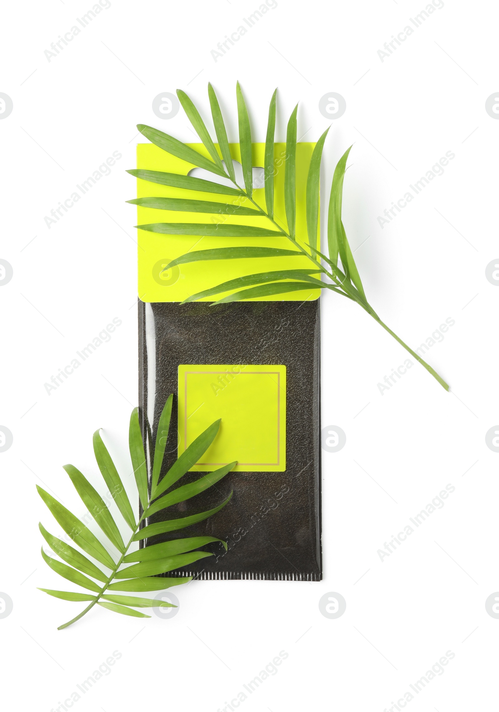 Photo of Scented sachet and green leaves on white background, top view