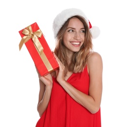 Photo of Happy young woman in Santa hat with gift box on white background. Christmas celebration