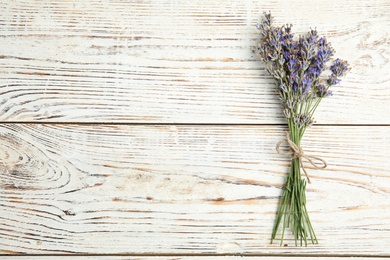 Blooming lavender flowers on wooden background, top view