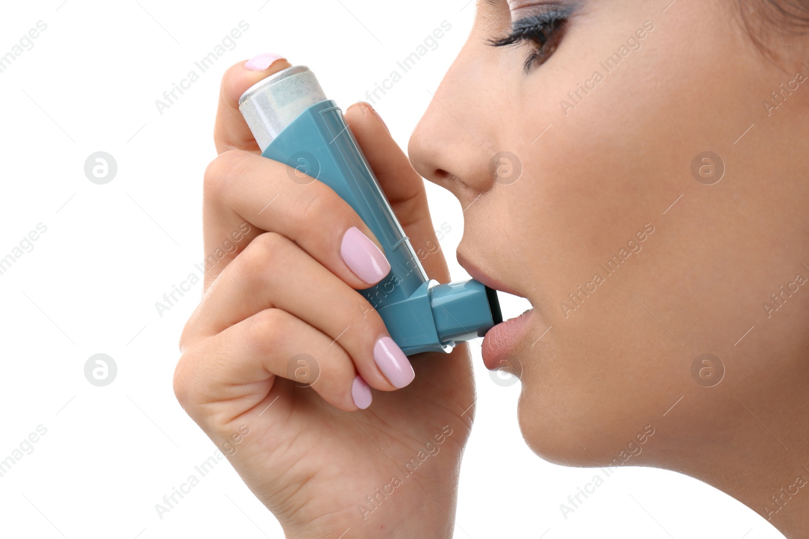 Photo of Young woman using asthma inhaler on white background, closeup