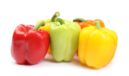 Fresh ripe bell peppers on white background