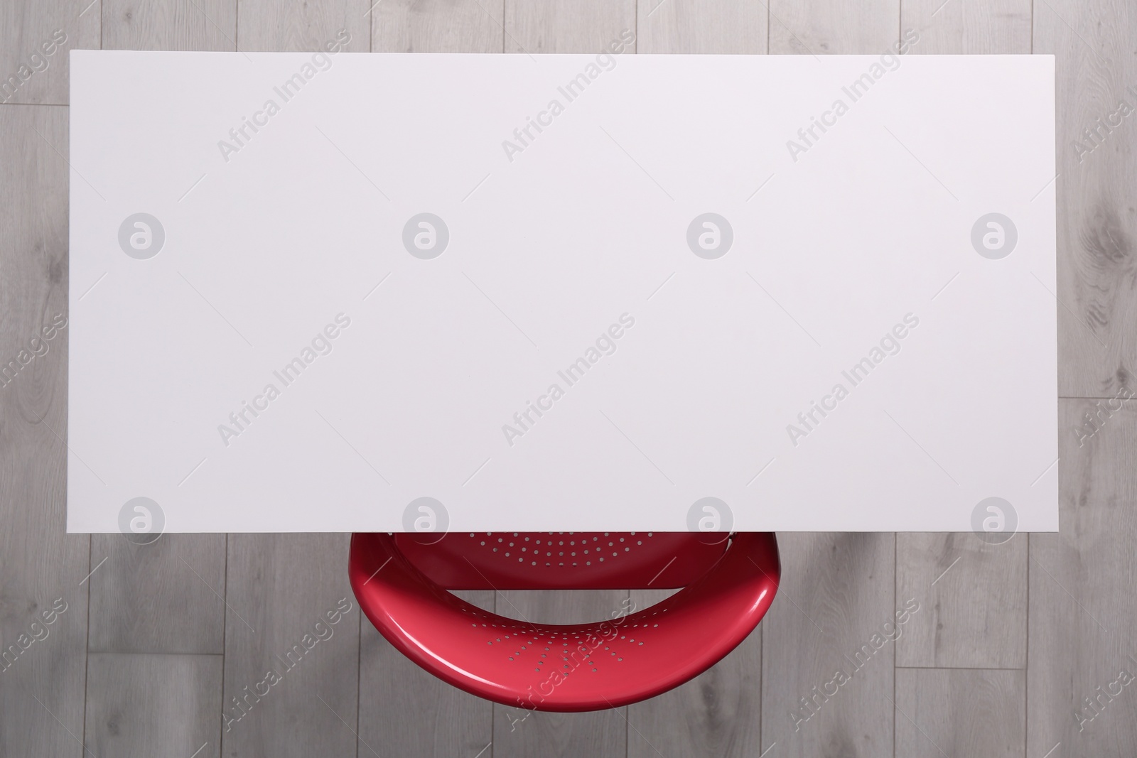 Photo of Empty white desk and chair indoors, top view