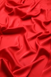 Photo of Texture of delicate red silk as background, closeup