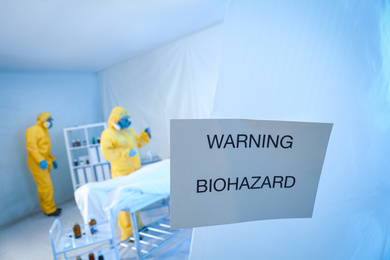 Photo of Sign with words WARNING BIOHAZARD near quarantine ward. Virus awareness