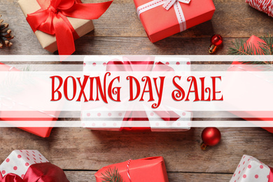 Image of Text Boxing Day Sale and gifts on wooden background, top view