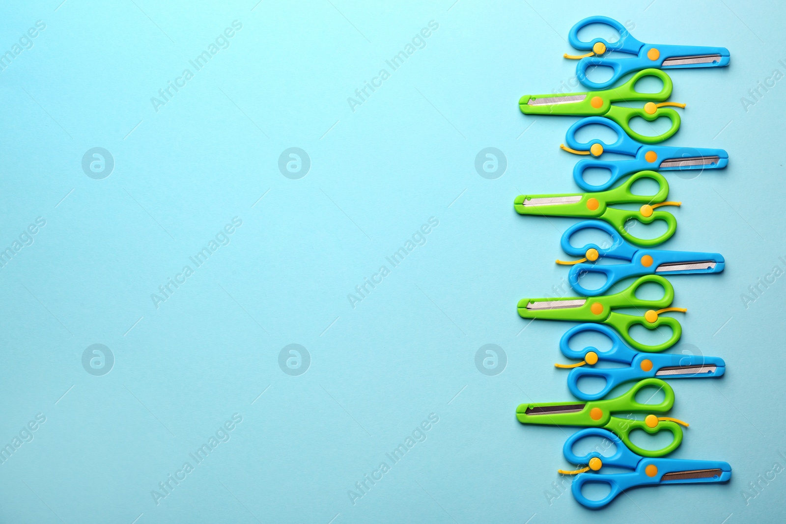 Photo of Set of training scissors on color background, flat lay. Space for text