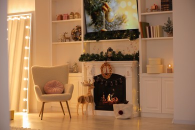 Photo of Living room with fireplace and Christmas decorations. Festive interior design