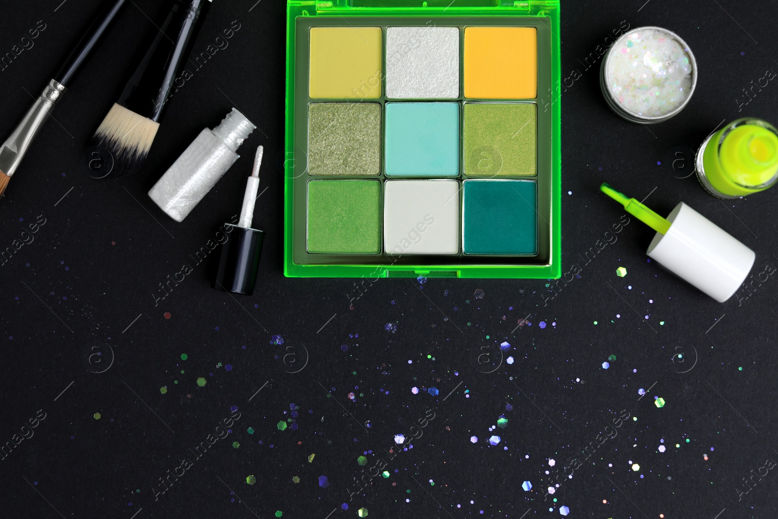Photo of Set of makeup products on black background, flat lay