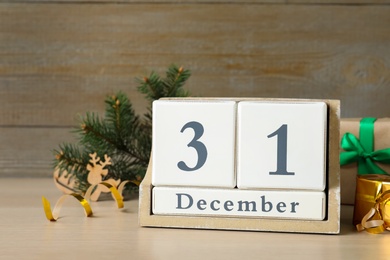 Photo of Wooden block calendar and Christmas decor on table. Holiday countdown