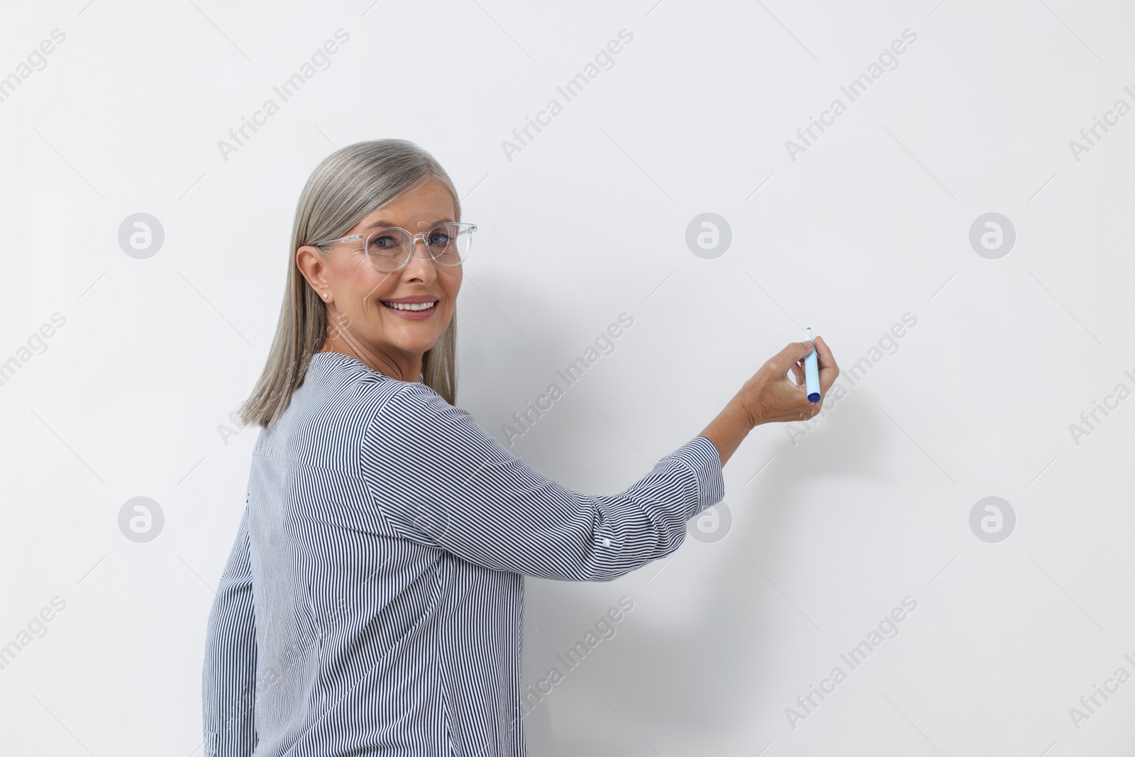 Photo of Portrait of professor explaining something at whiteboard
