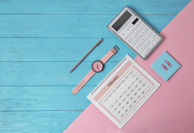 Photo of Flat lay composition with calendar on color background, space for text