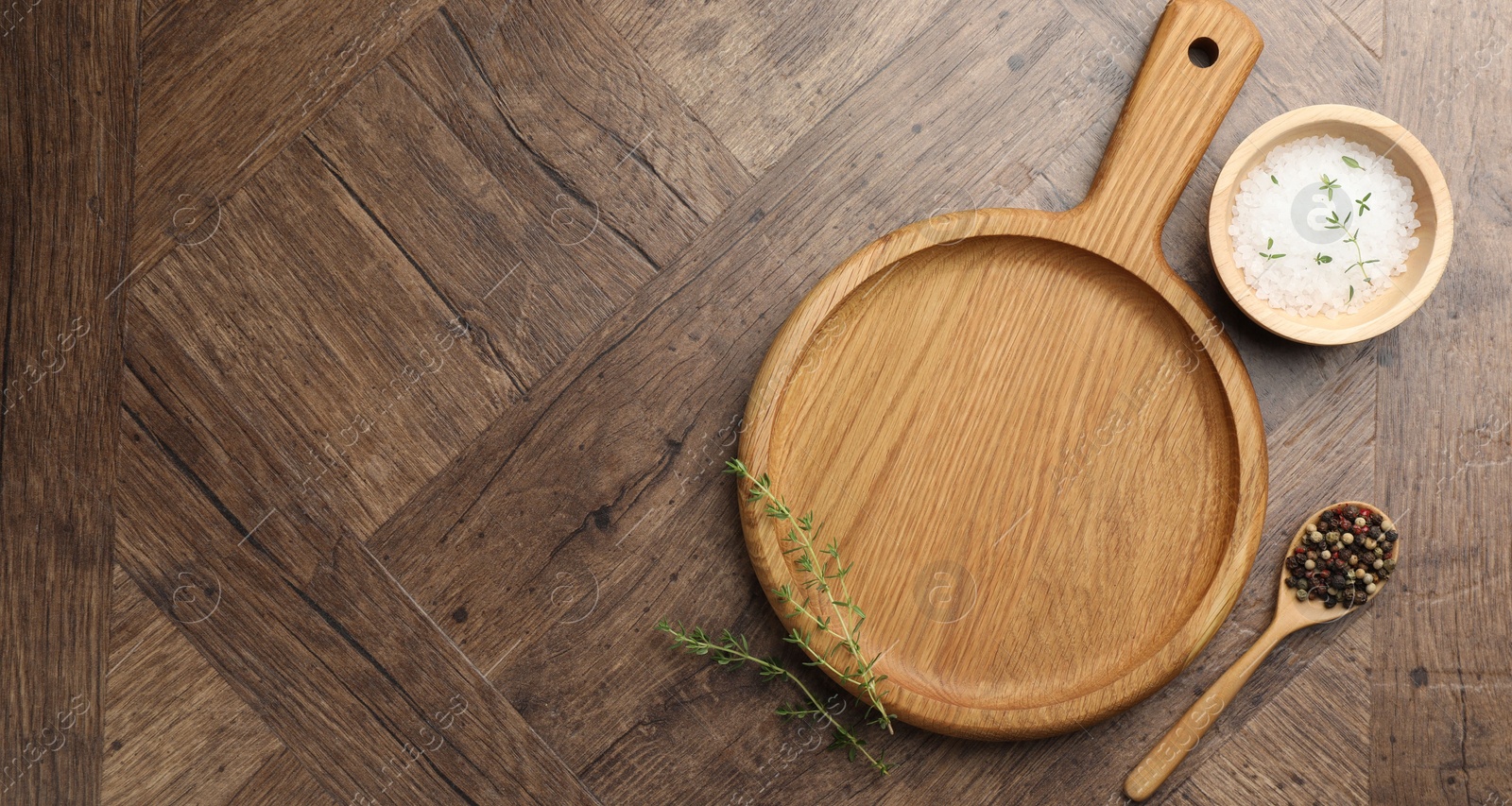 Photo of Cutting board and different spices on wooden table, flat lay. Space for text