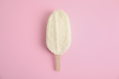 Photo of Ice cream with glaze on pink background, top view