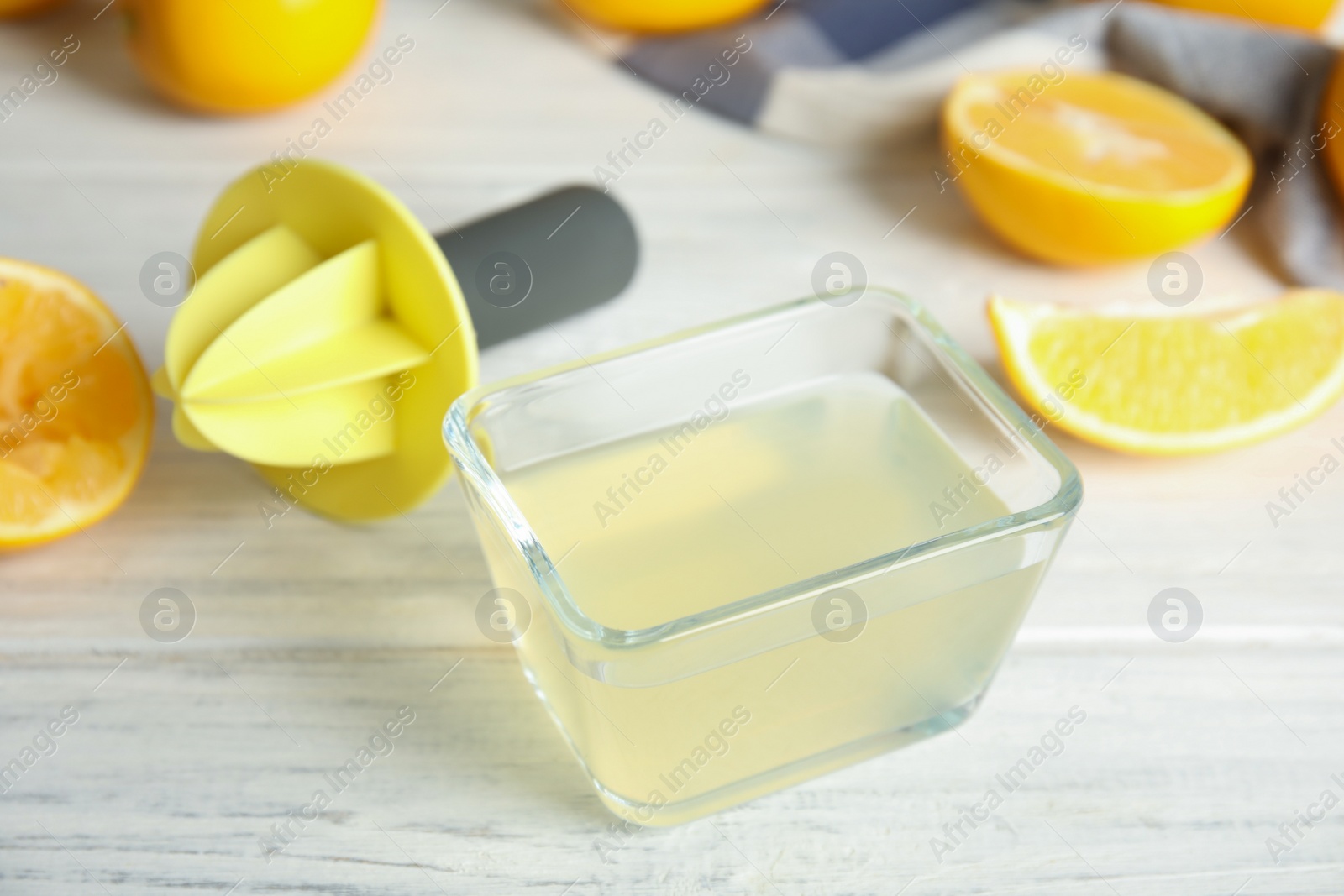 Photo of Freshly squeezed lemon juice on white wooden table