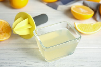 Freshly squeezed lemon juice on white wooden table