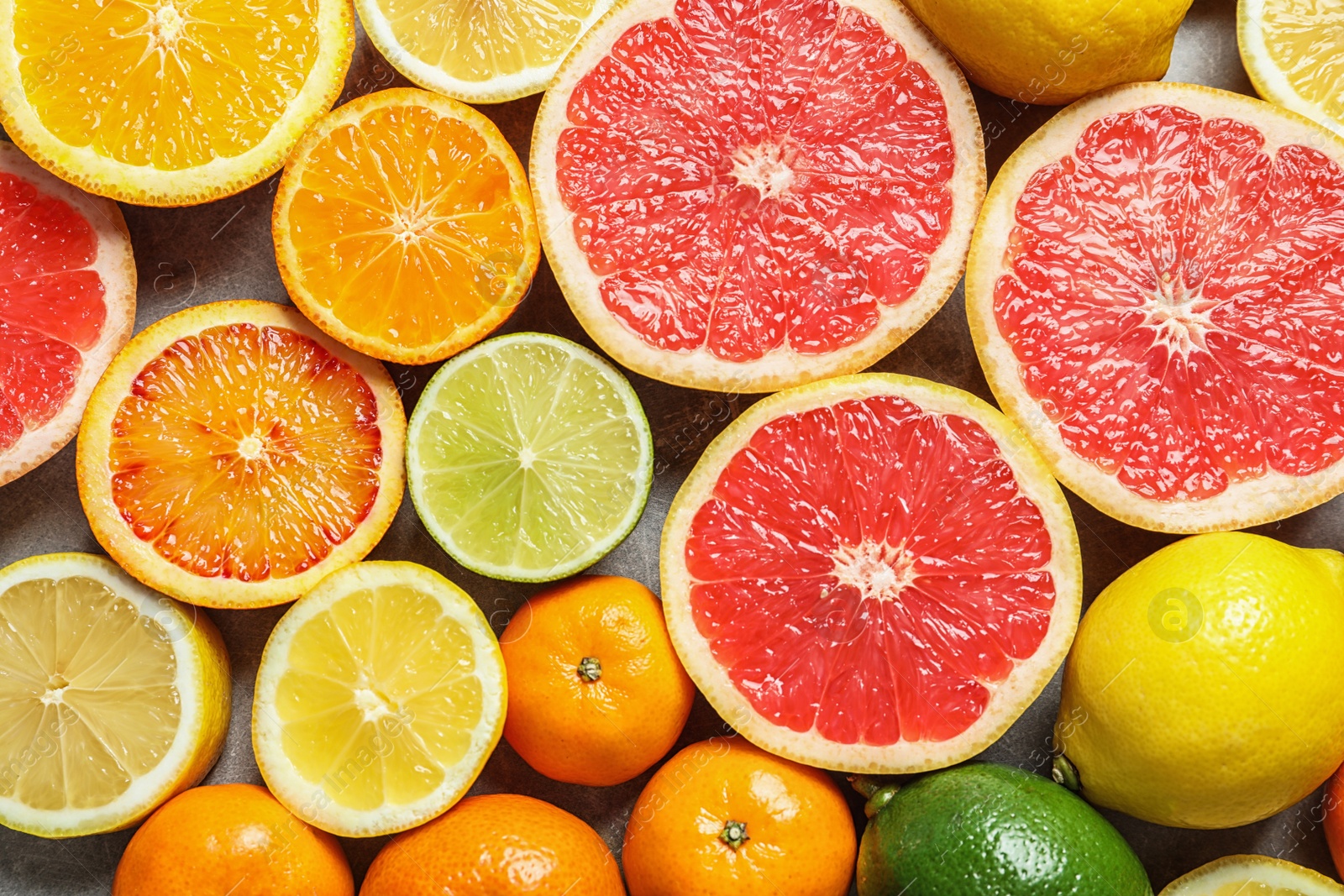 Photo of Different citrus fruits as background, top view