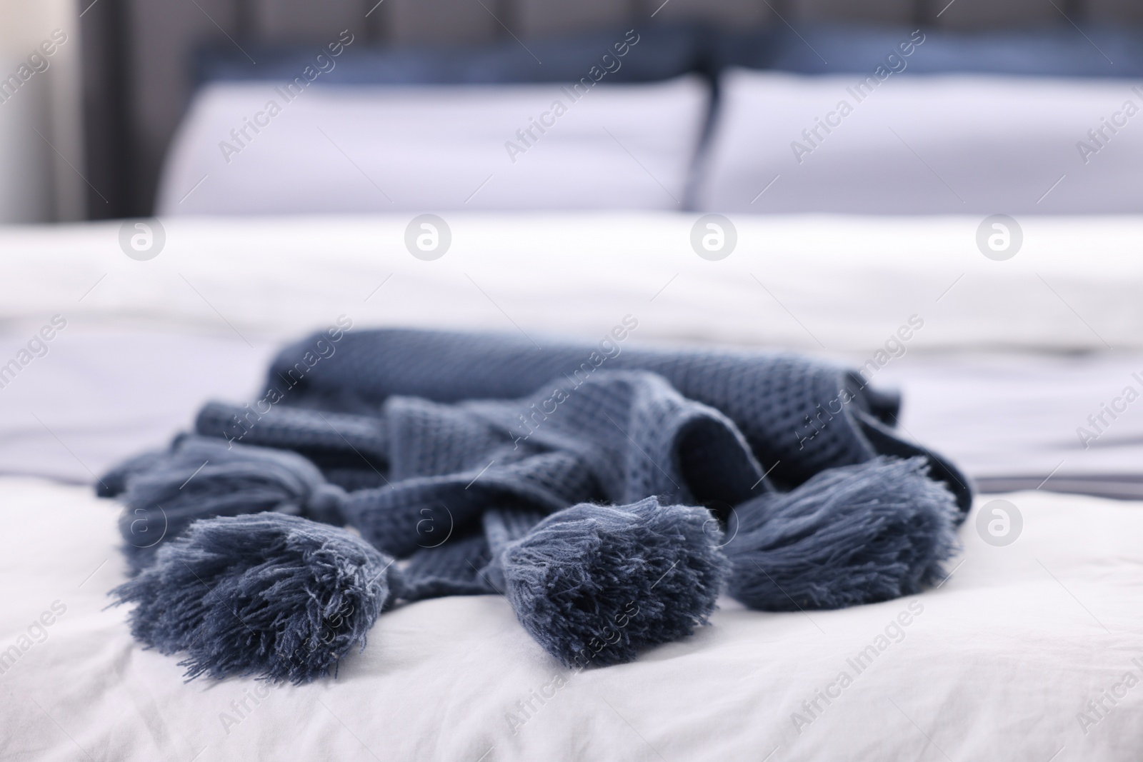 Photo of Soft blue plaid on bed in room, closeup