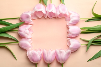 Beautiful frame made of tulips for Mother's Day on color background