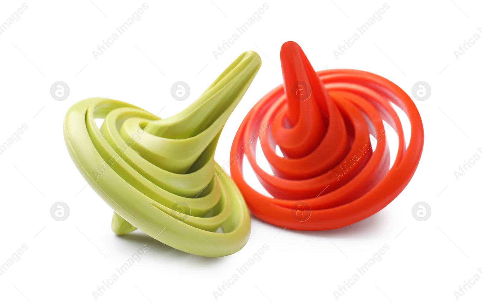 Photo of Two colorful spinning tops on white background