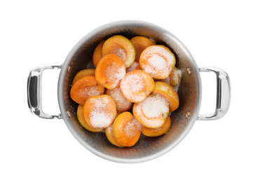 Photo of Pot with apricots and sugar on white background, top view. Making delicious jam