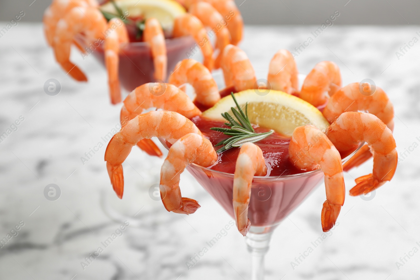 Photo of Delicious shrimp cocktail with tomato sauce, closeup