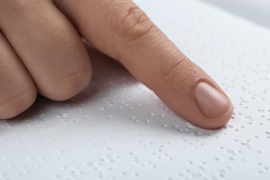 Blind person reading book written in Braille, closeup